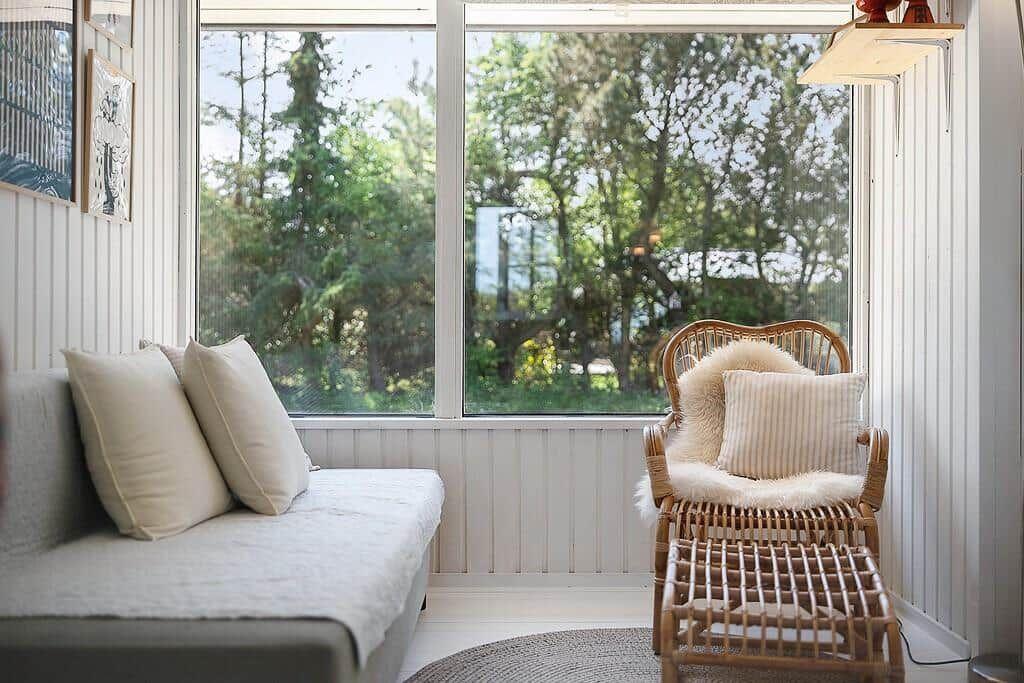 Room with sofa, chair, and large window for view