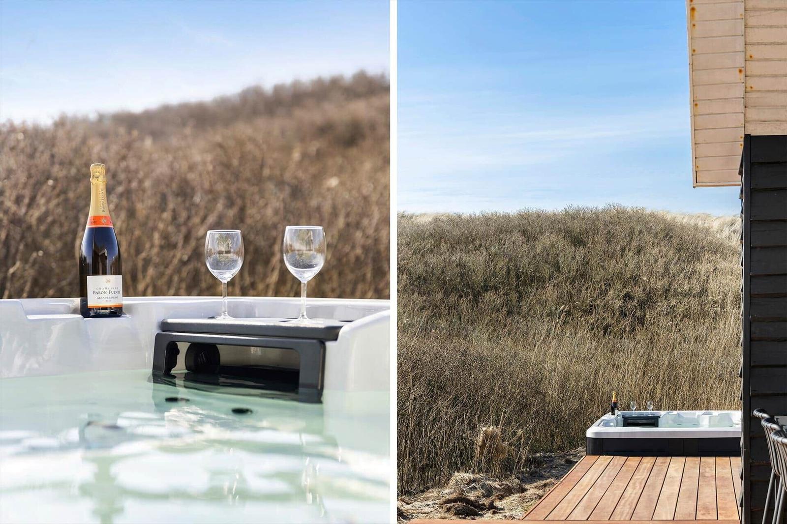 Hochwertiger Whirlpool mit Champagner und Gläsern auf einer Terrasse mit Blick auf trockenes Gras.
