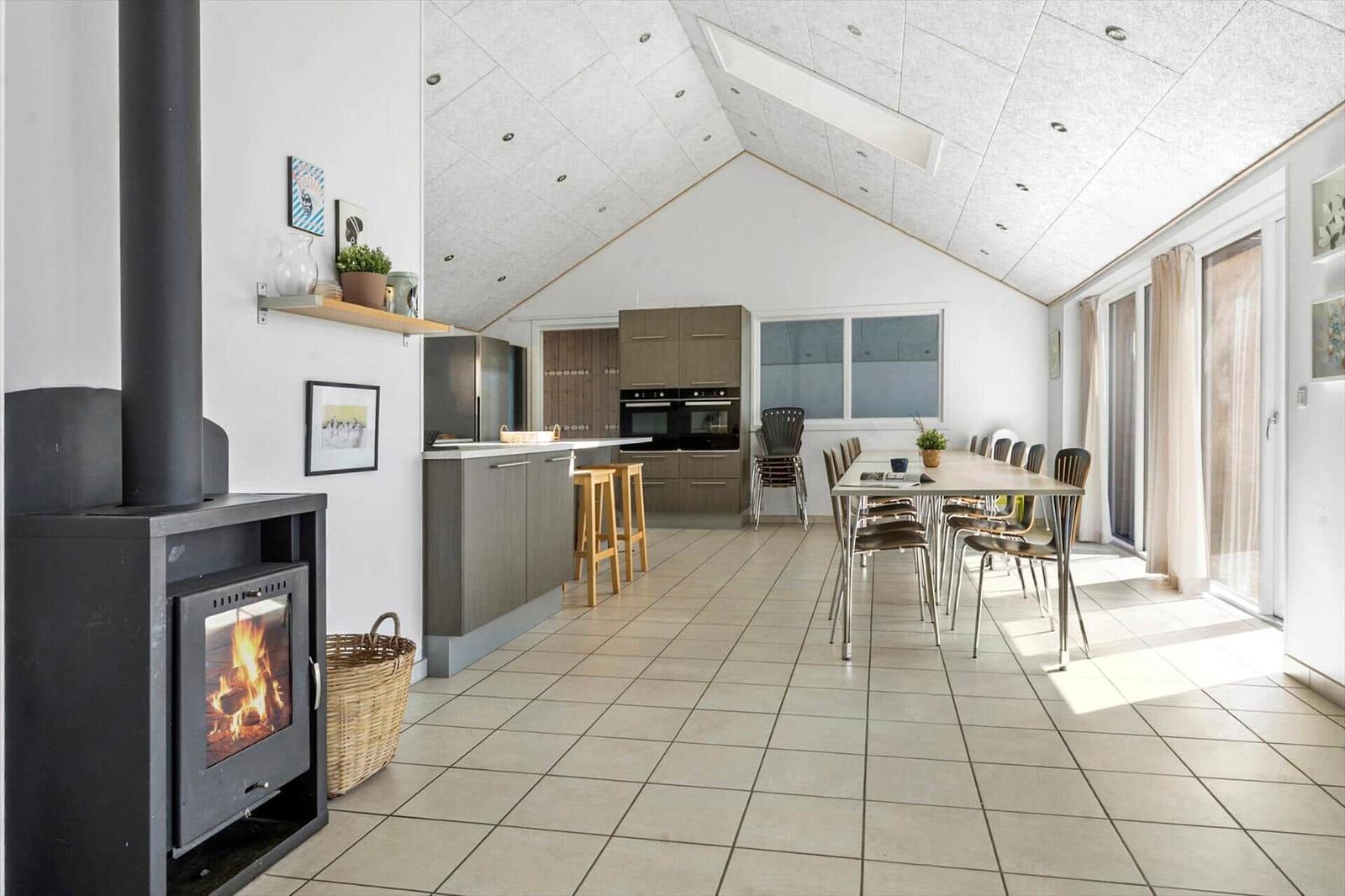 Kitchen with dining table, fireplace, and natural light
