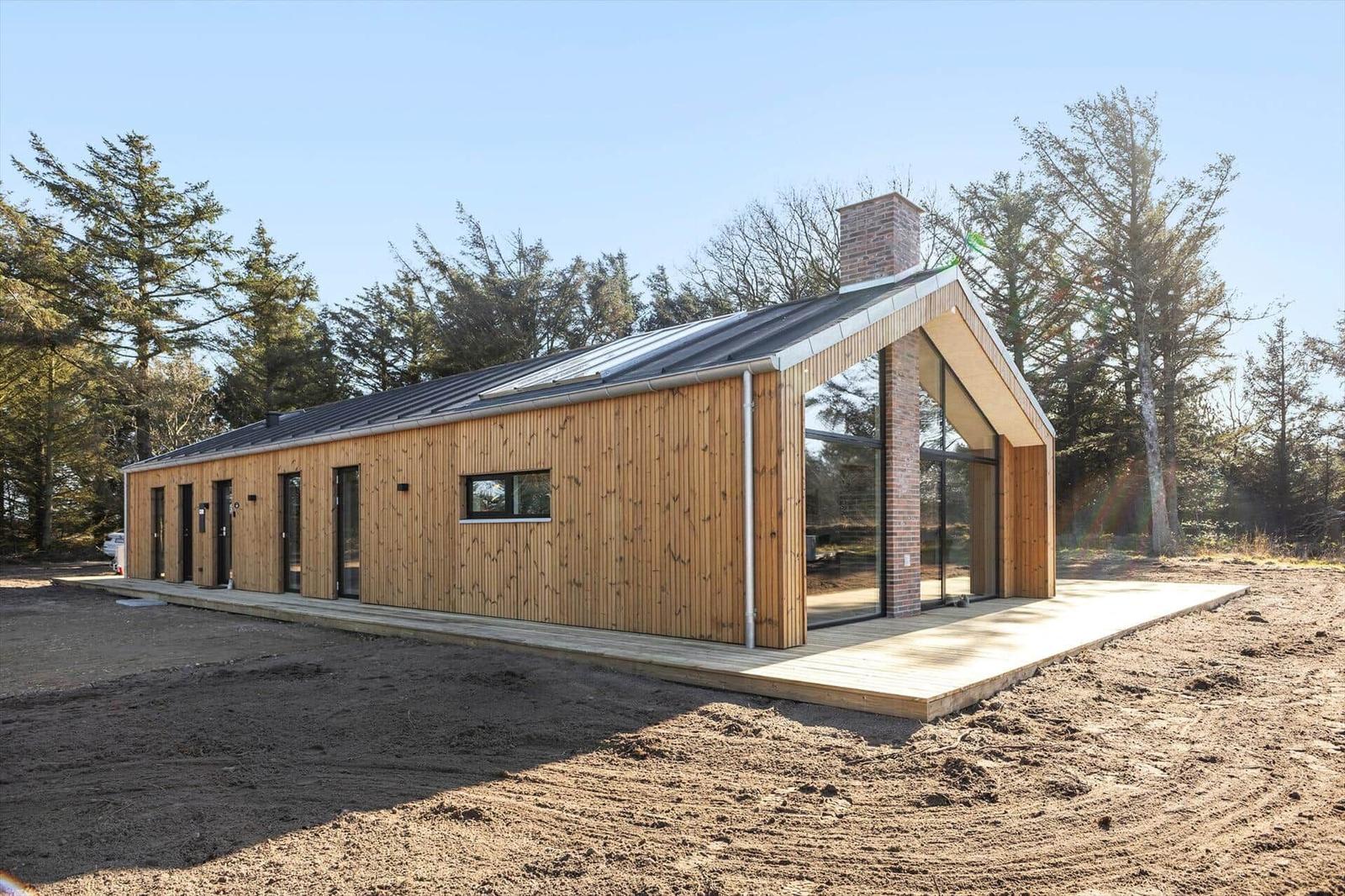 Moderne Holzhütte mit großem Glasbereich und Terrasse im Wald