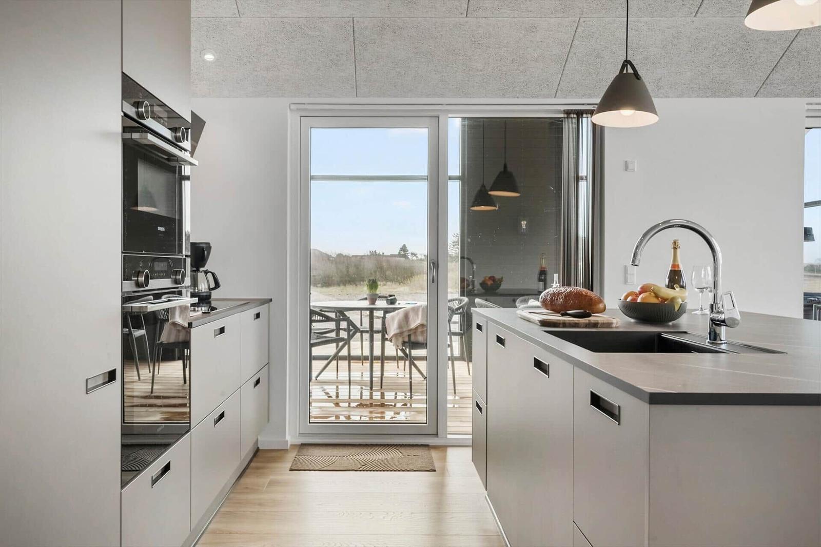 Modern kitchen with view of terrace and garden