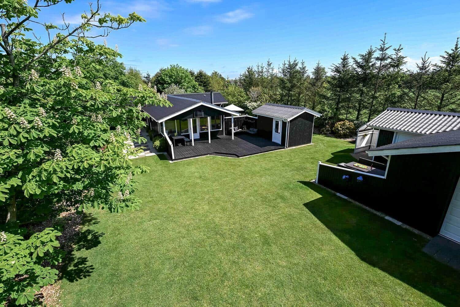 Modern holiday home with terrace and large garden. Surrounded by trees and greenery.