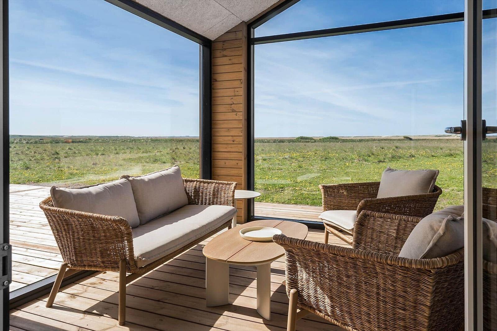 Terrasse mit Sitzgruppe und Blick auf grünes Feld