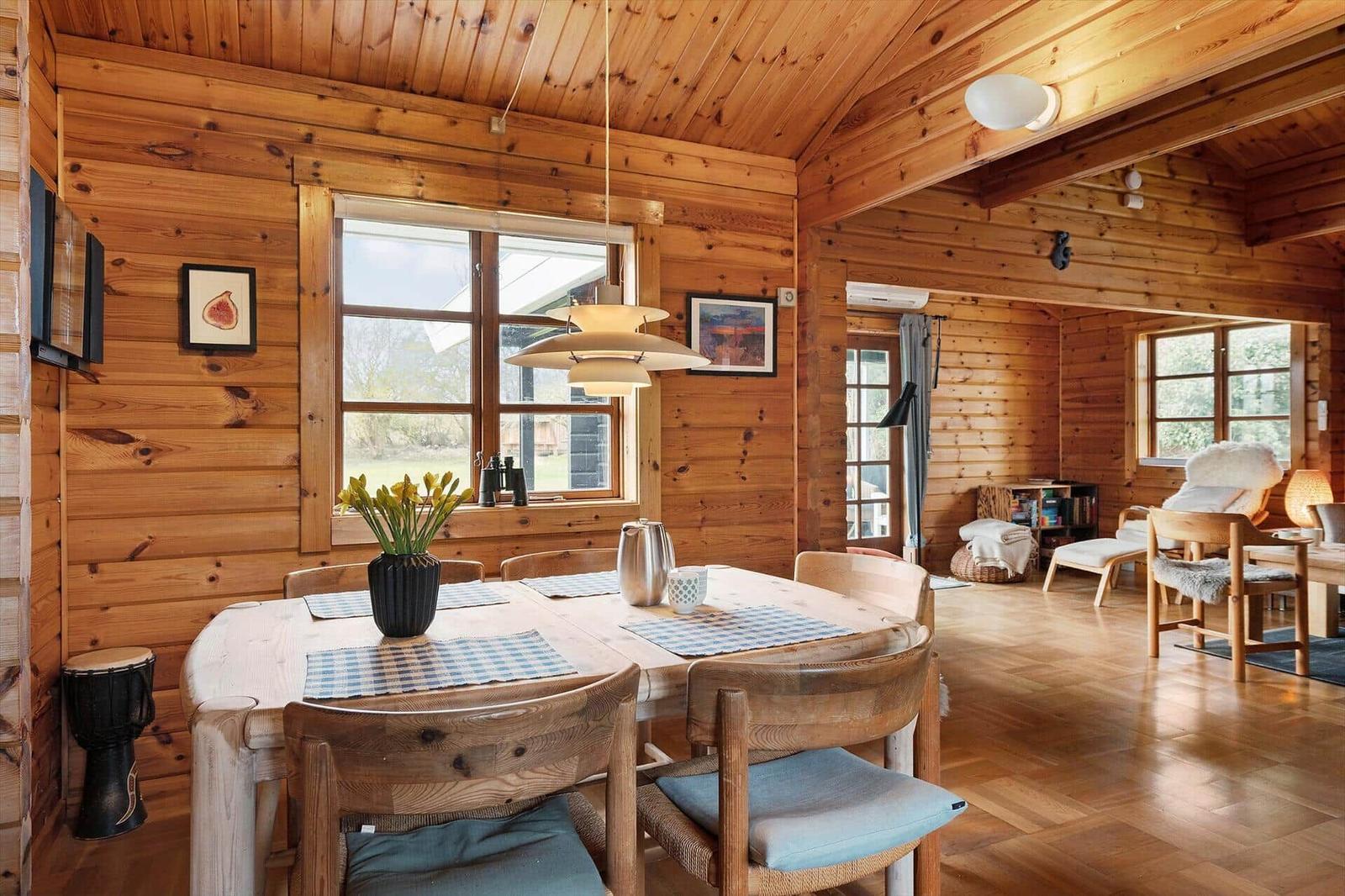 Wood-paneled kitchen with dining table and seating