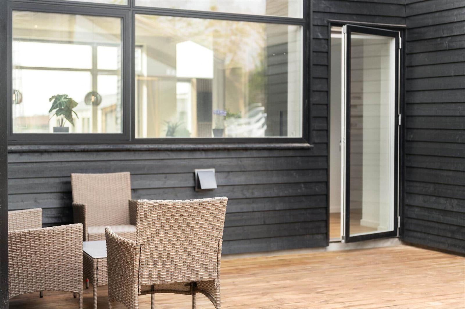 Terrasse mit Sitzgruppe und Glastür zur Wohnung.