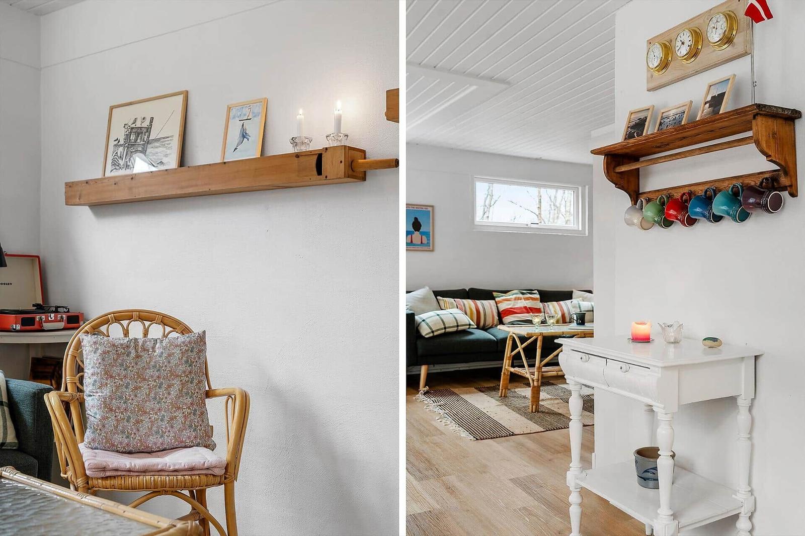 Living room with sofa, table, and wall shelf. Left: chair with cushion and wall shelf with pictures.