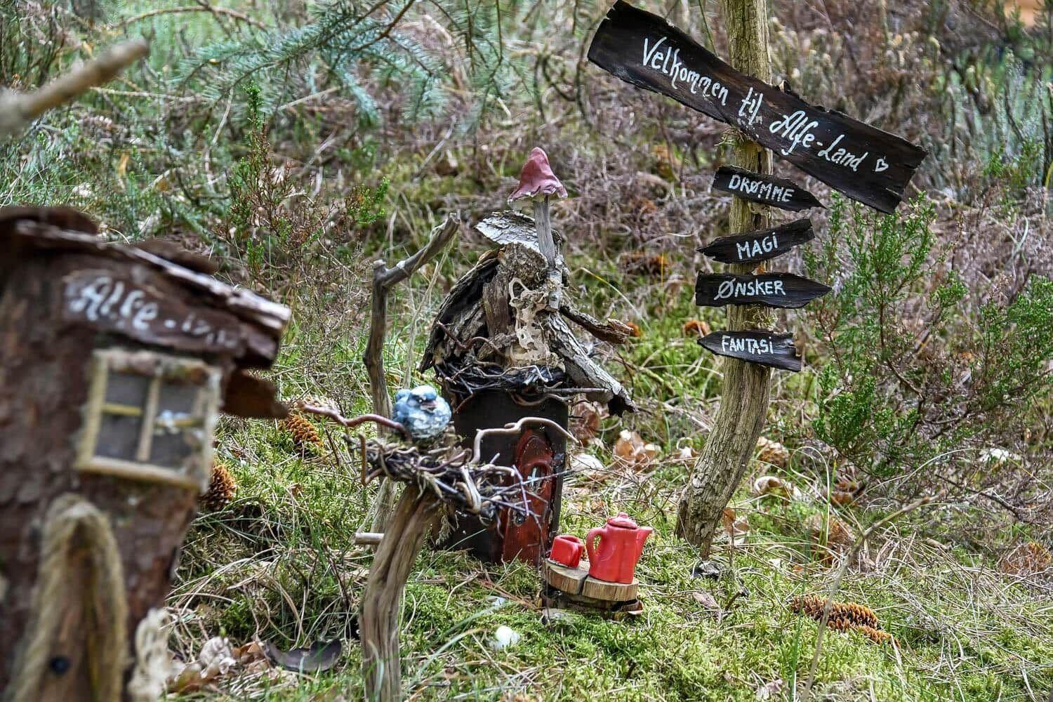 Willkommen im Zauberwald mit kleinem Hüttenhaus und Wegweiser zu Träumen und Fantasie.
