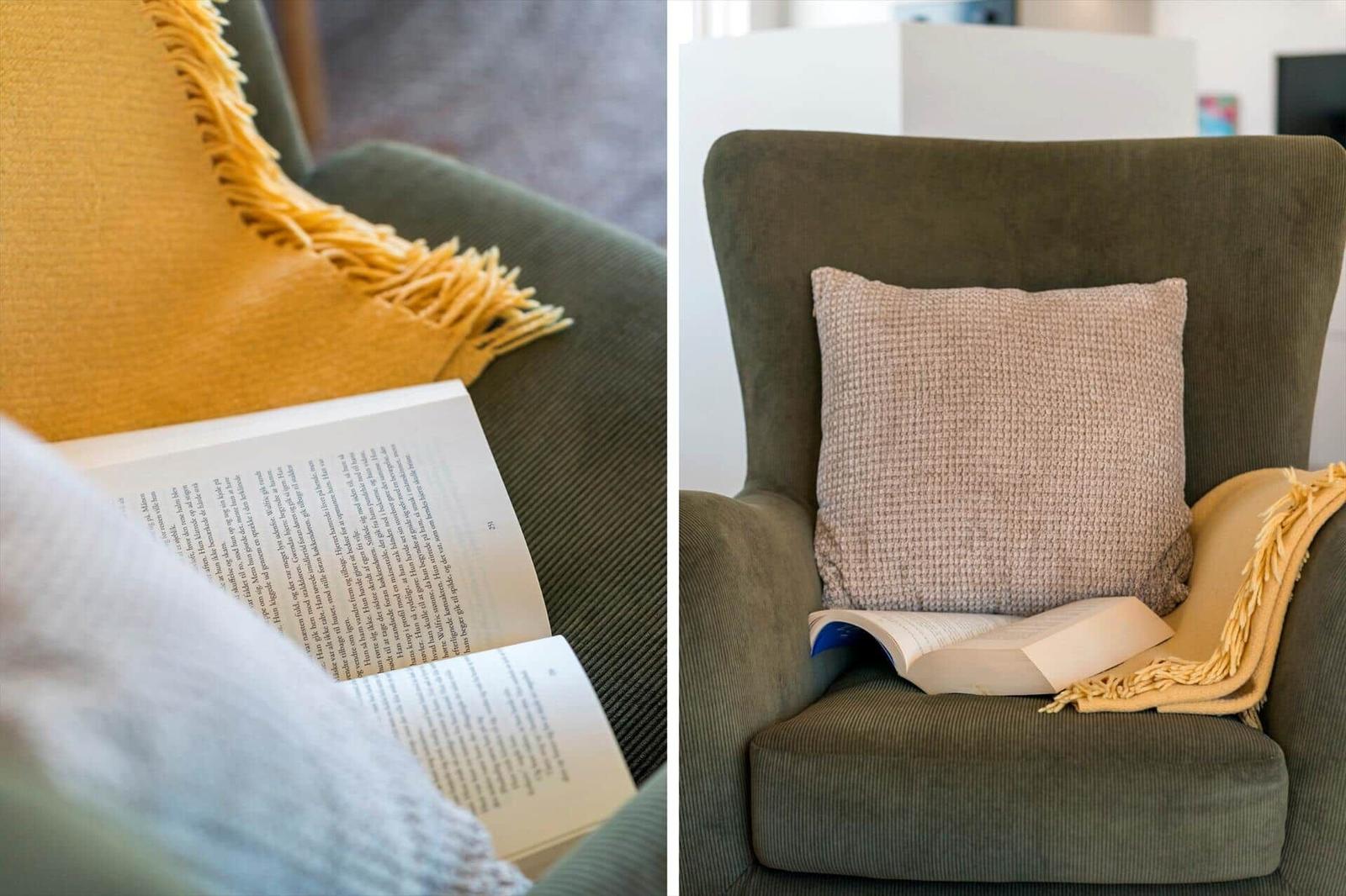 Ein Sessel mit Kissen und Decke. Ein Buch liegt auf dem Sitz.