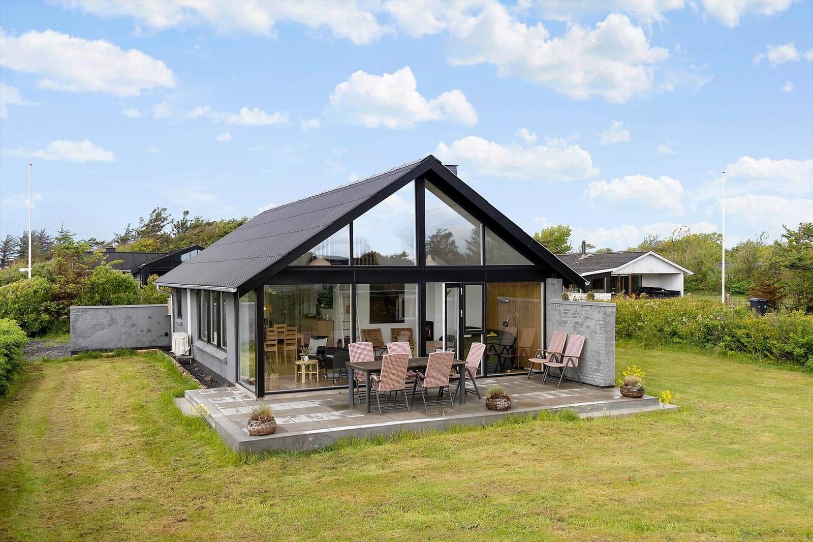Modern villa with large glass area and terrace in the garden