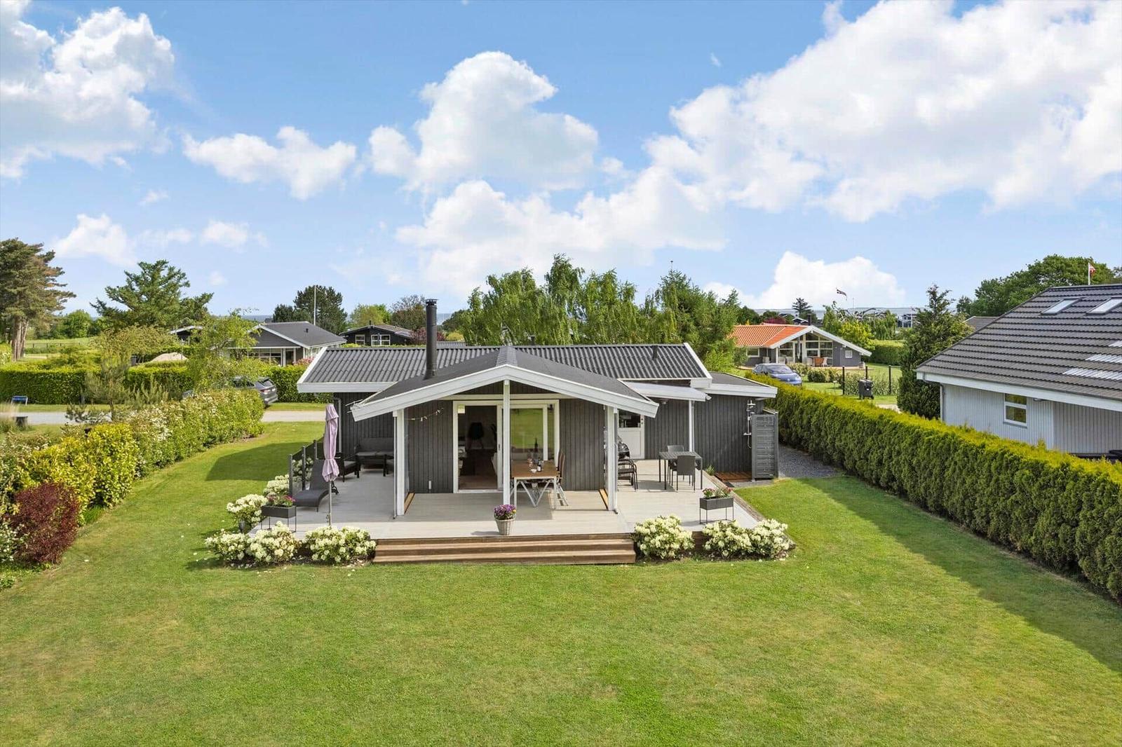 A house with terrace, garden, and view of the sky.