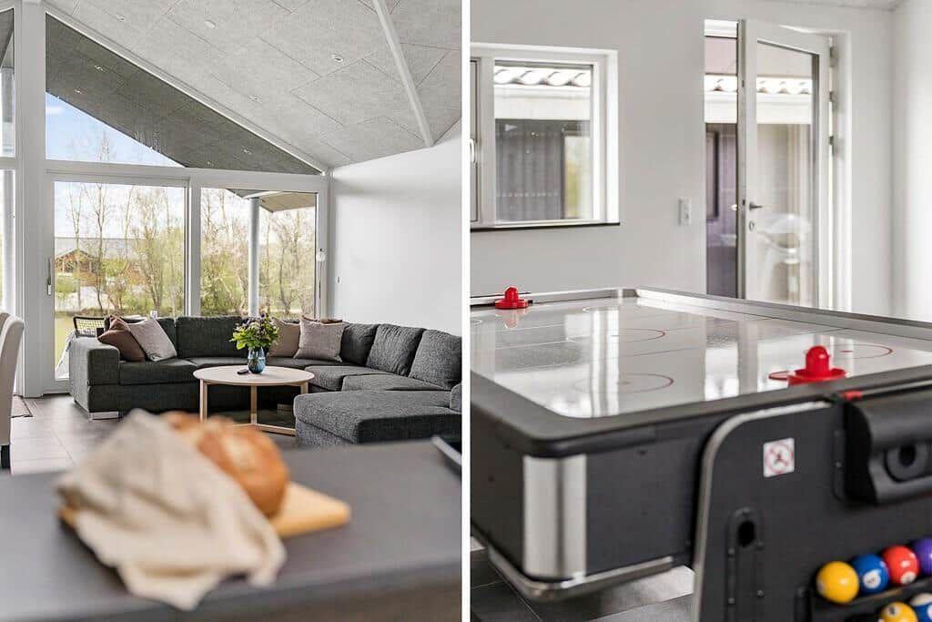 Wohnbereich mit großem Sofa und Blick auf Garten. Nebenraum mit Eishockeytisch.