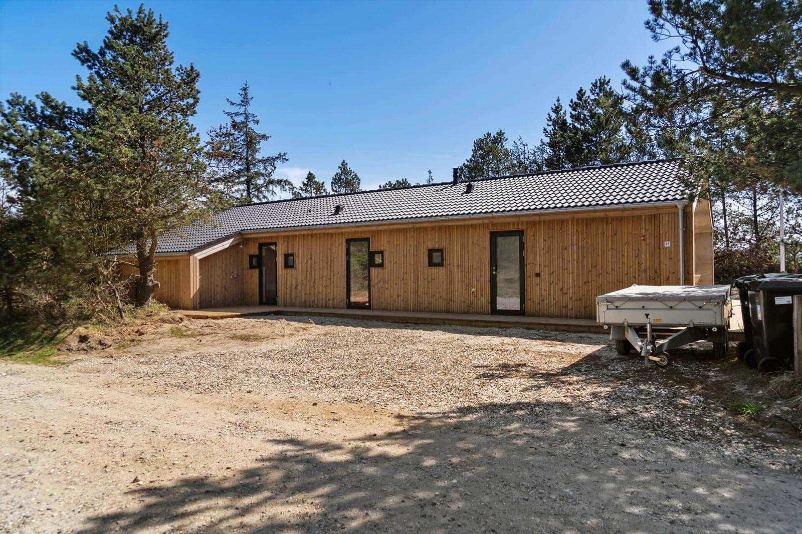 Wooden house with roof and windows in forest area