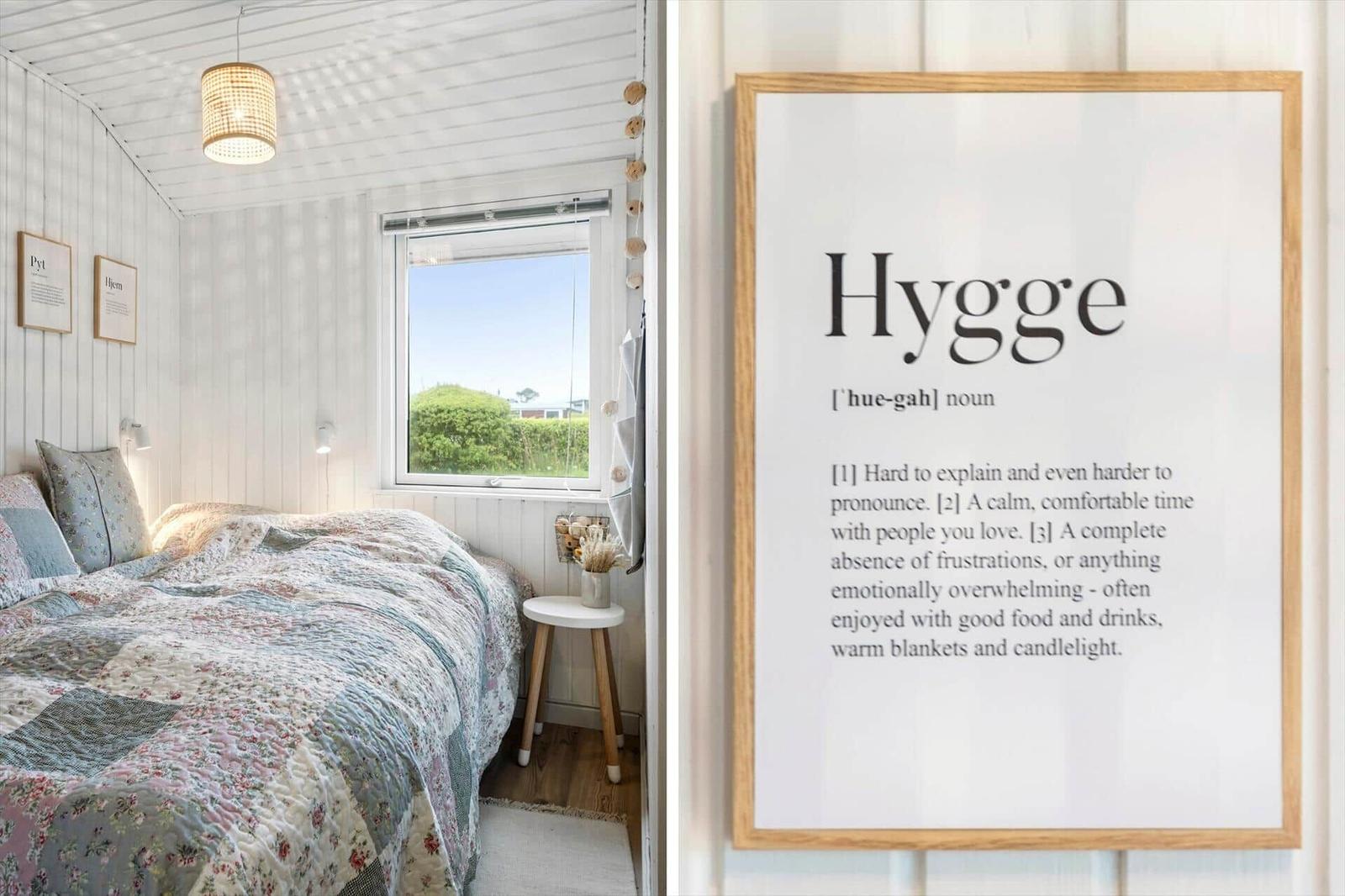 Bedroom with bed, window, and wall art Hygge.