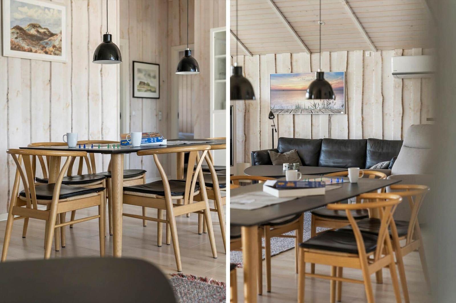 Essbereich mit Holztisch und Stühlen, Wandbild und Hängelampen