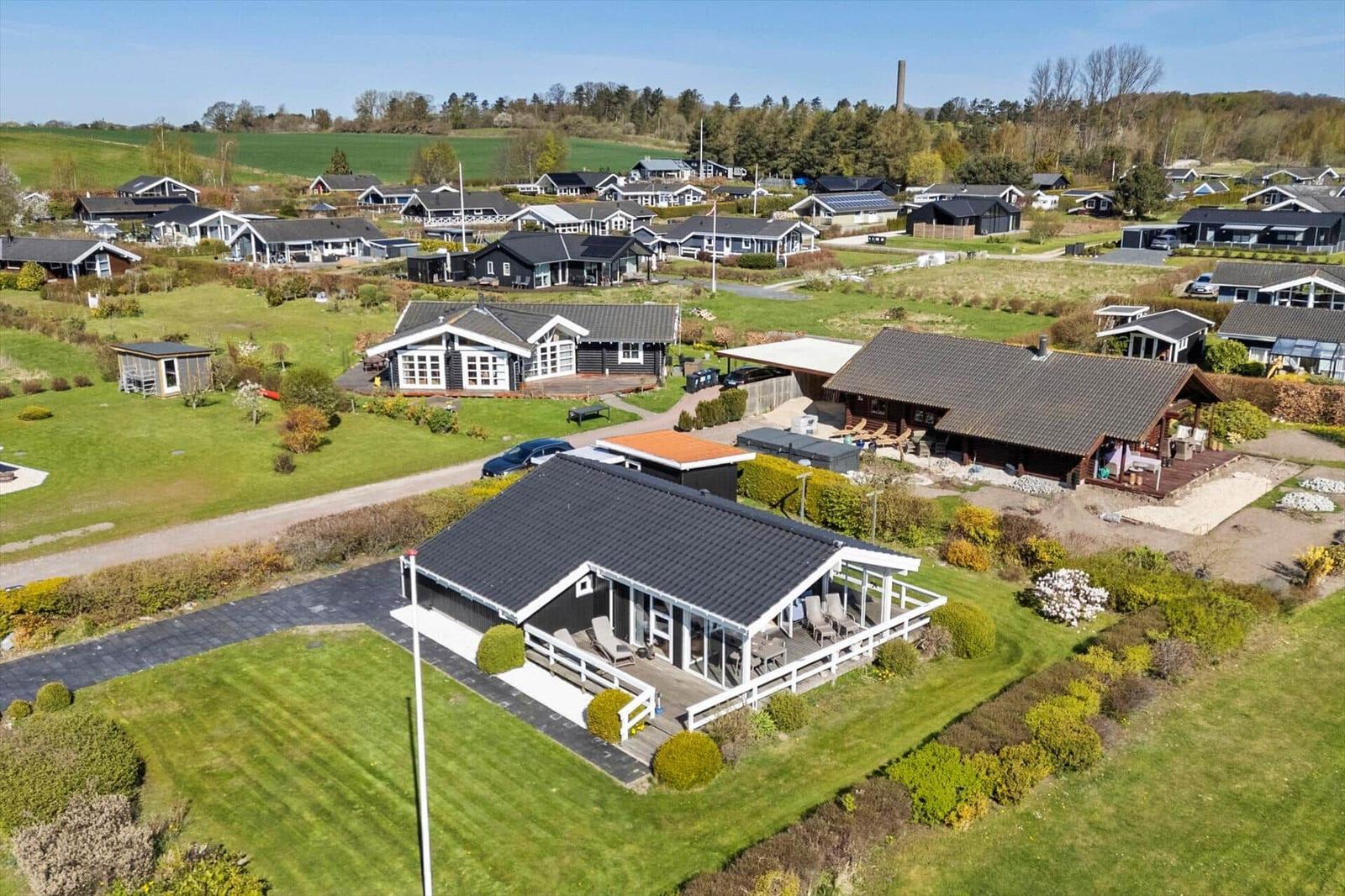 Modern holiday home with terrace and garden. Surrounded by other houses and meadows.