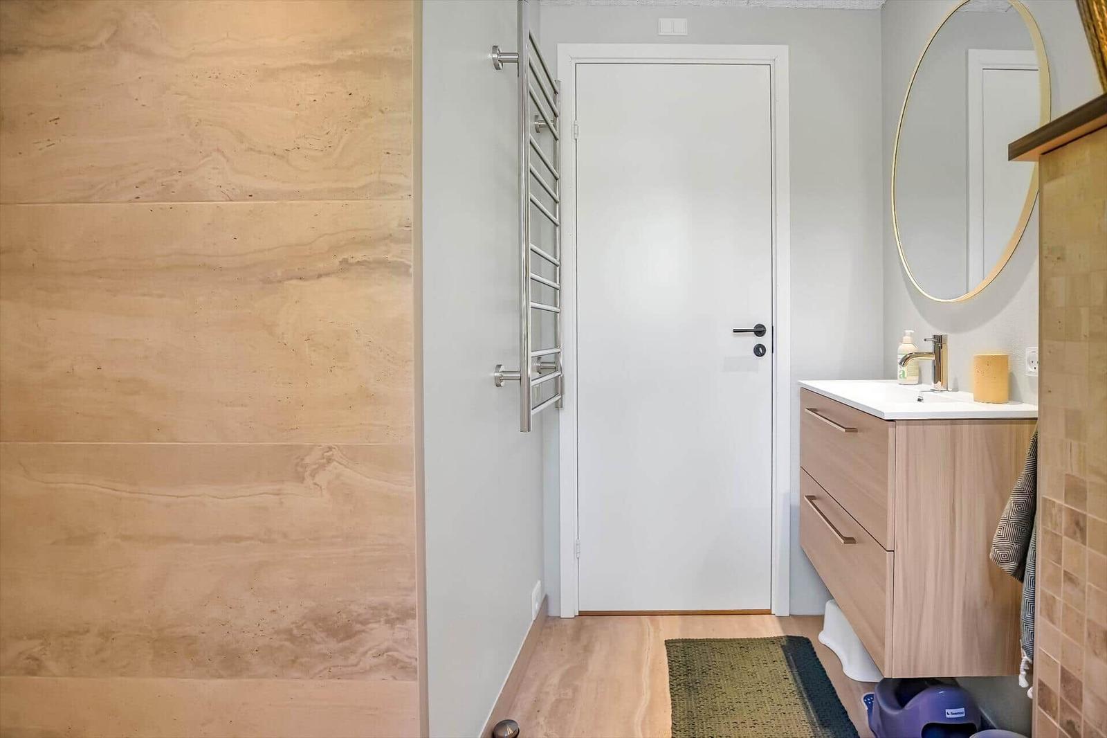 Bathroom with sink, mirror, and heater.