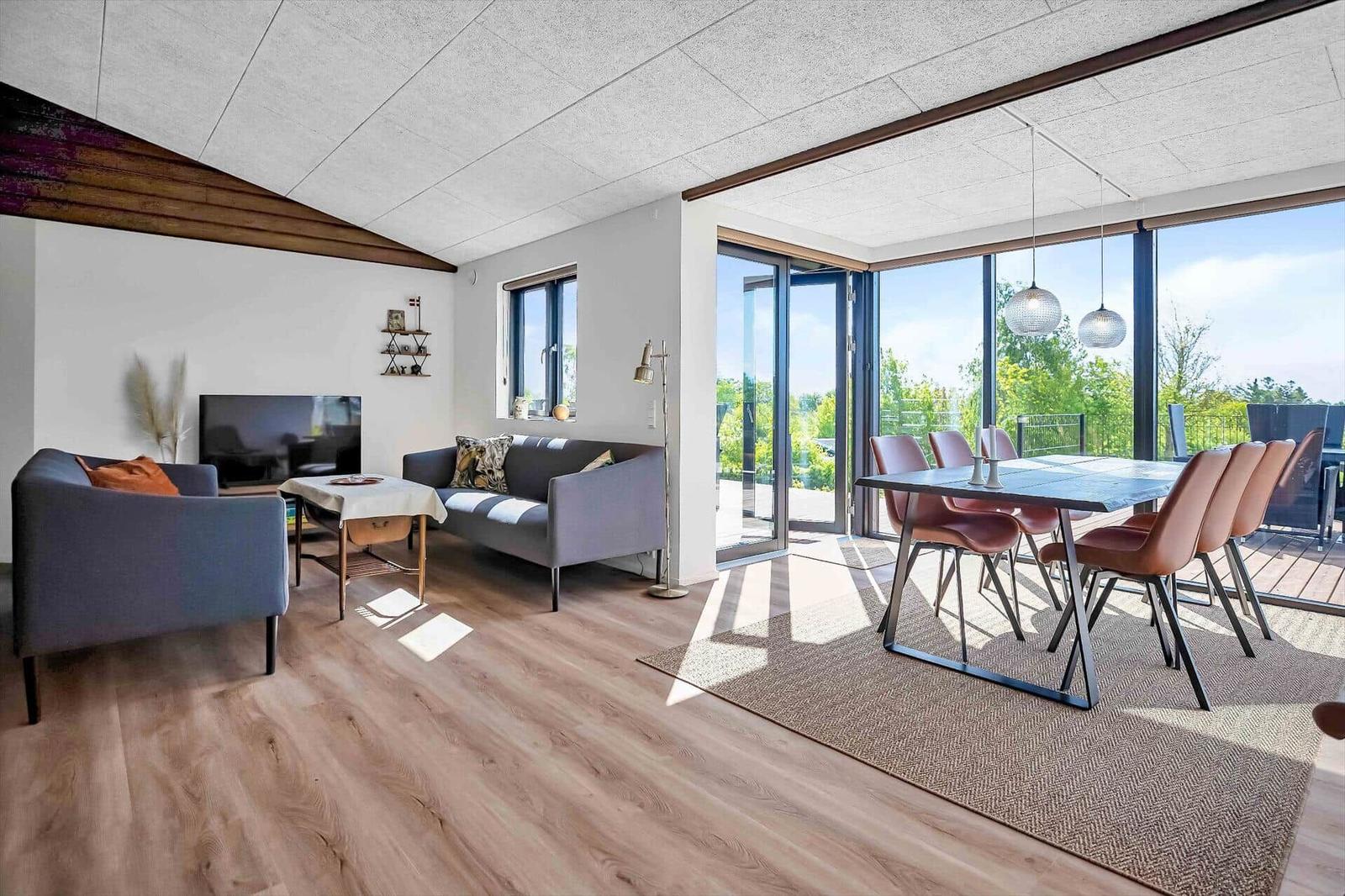 Living and dining area with large window view to the terrace.