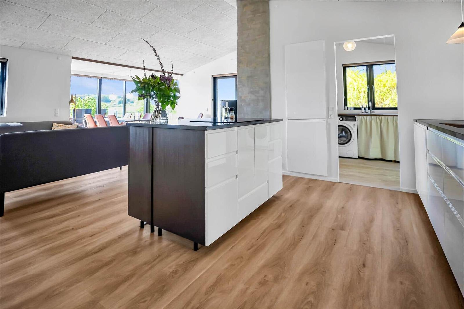 Kitchen with island, living area, and view of the landscape.