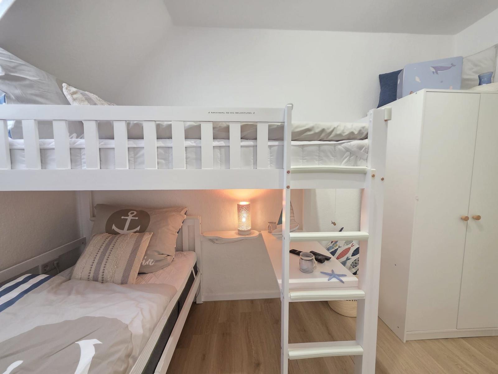 Doppelbett mit unterer Schlafcouch, Nachttisch mit Lampe und Kleiderschrank