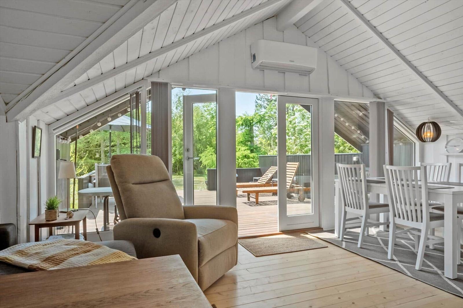 Living and dining area with view of the terrace and garden.