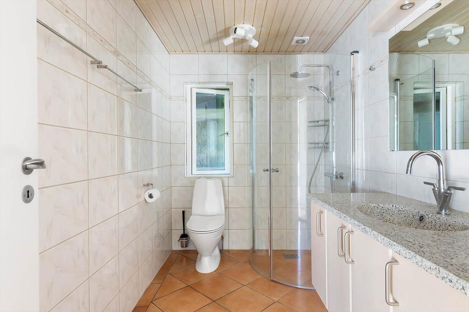 Badezimmer mit Dusche, Toilette und Waschbecken