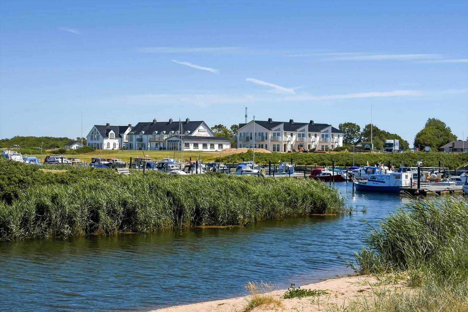 Harbor with boats and white houses along the shore