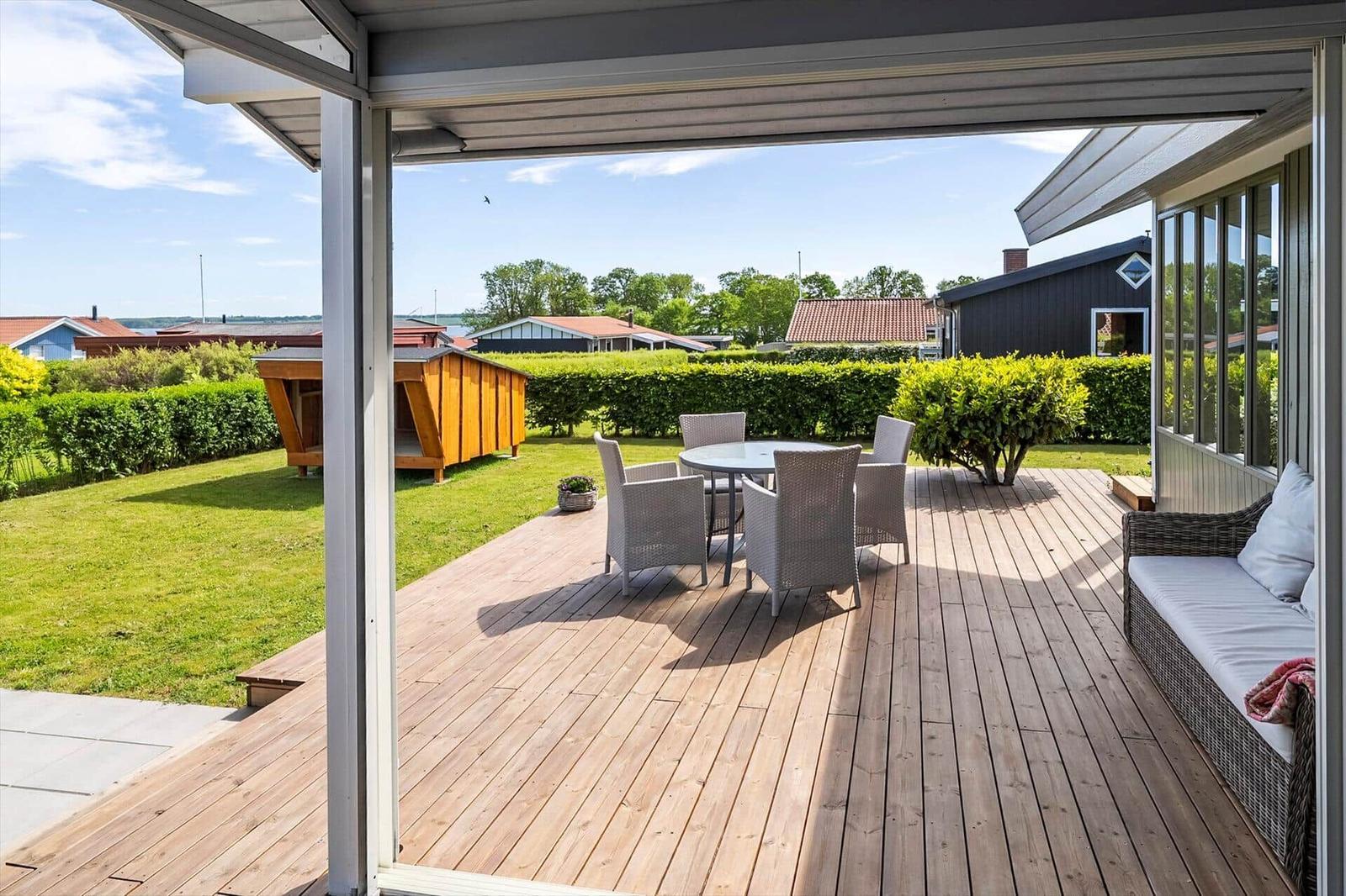 Deck with seating, garden, and view of houses.