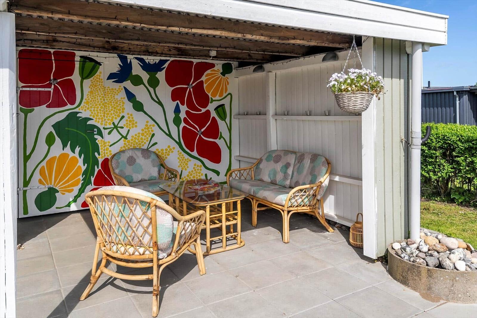 Terrace with bamboo furniture and colorful wall mural