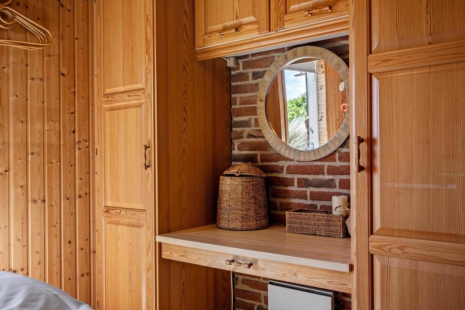 Wooden closet with mirror and basket on work surface