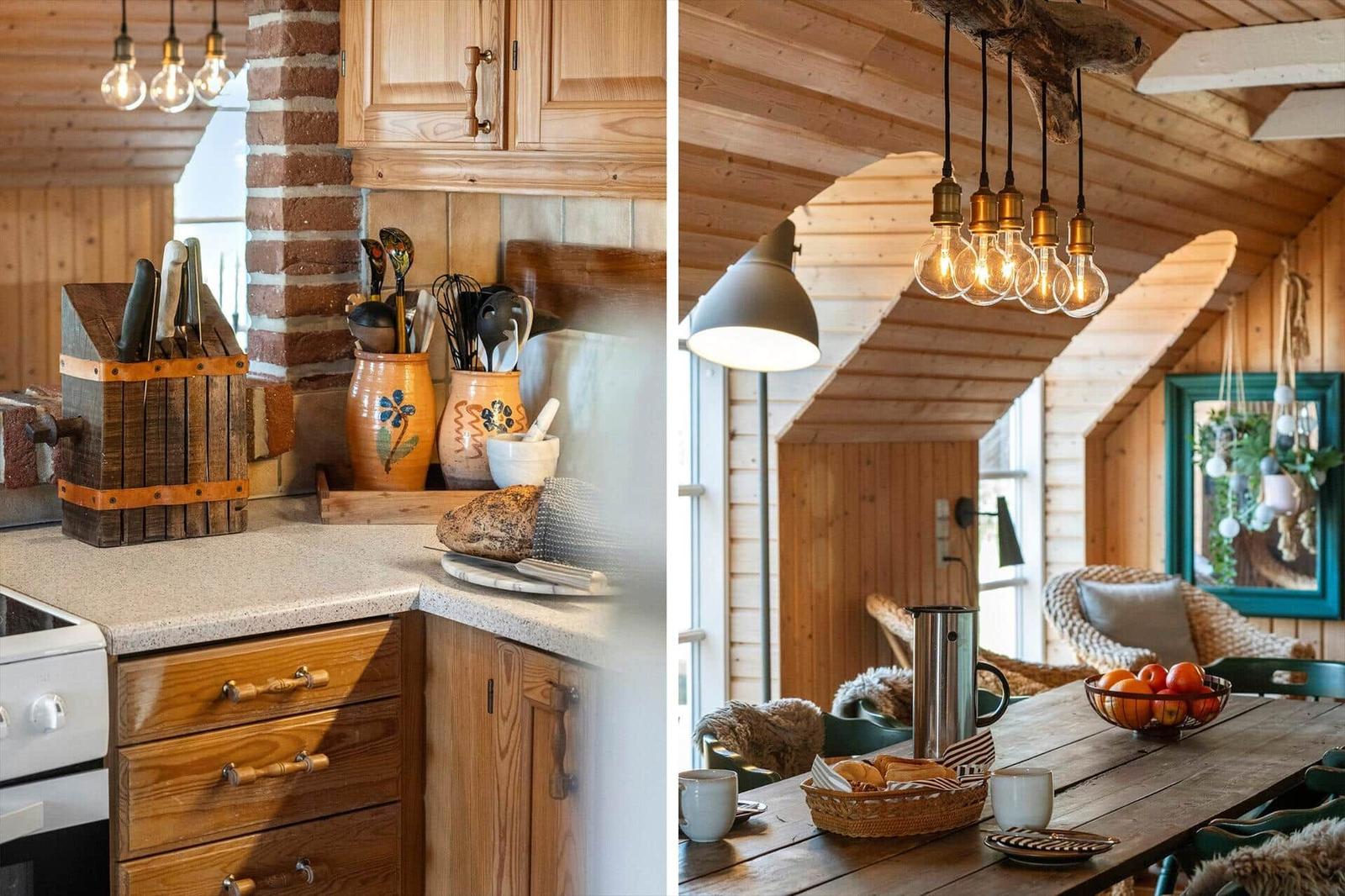 Kitchen with wooden cabinets and stone wall. Dining area with wooden table and pendant lamp.