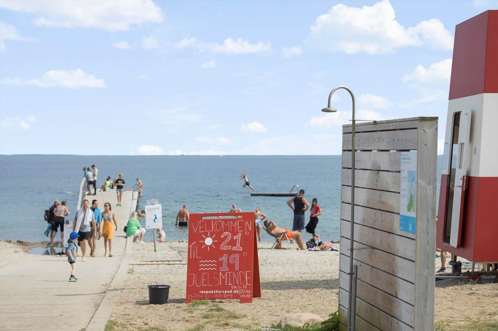 Welcome sign at beach with swimming area and shower station