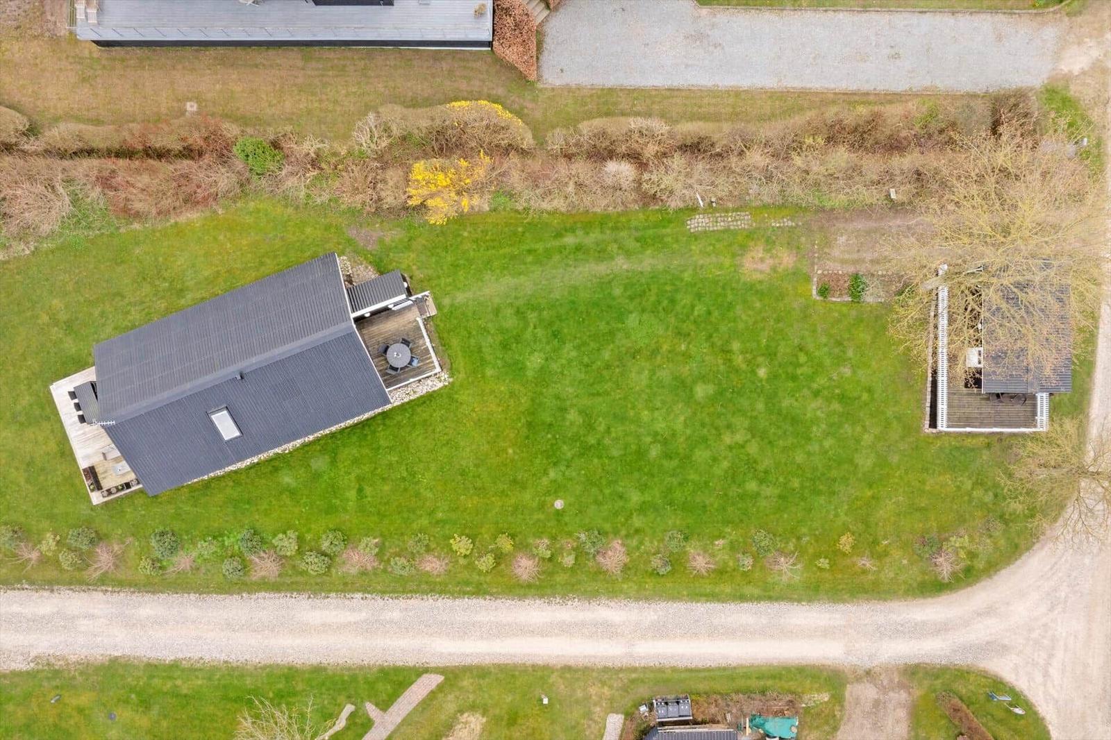 Aerial view of a vacation rental with large garden and terrace.