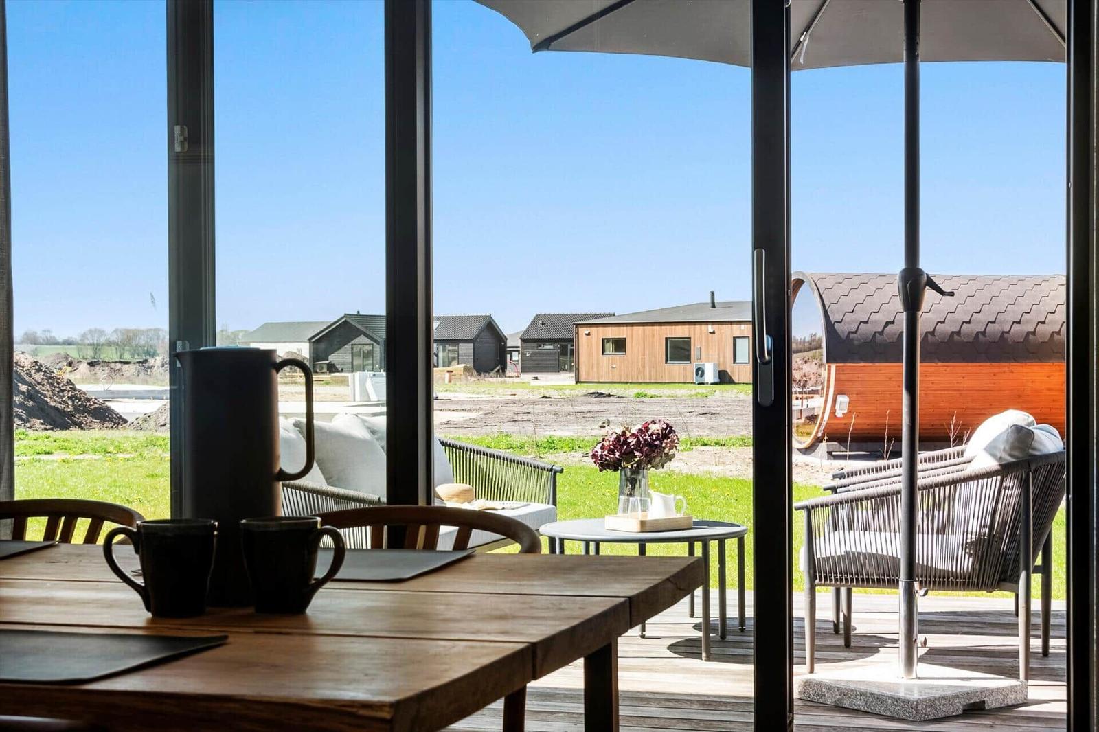 Terrace with seating and view of modern wooden houses.