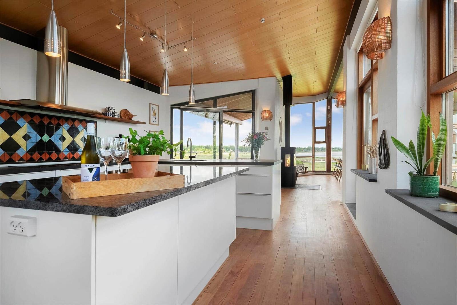 Kitchen with wooden ceiling, countertop, and view of water