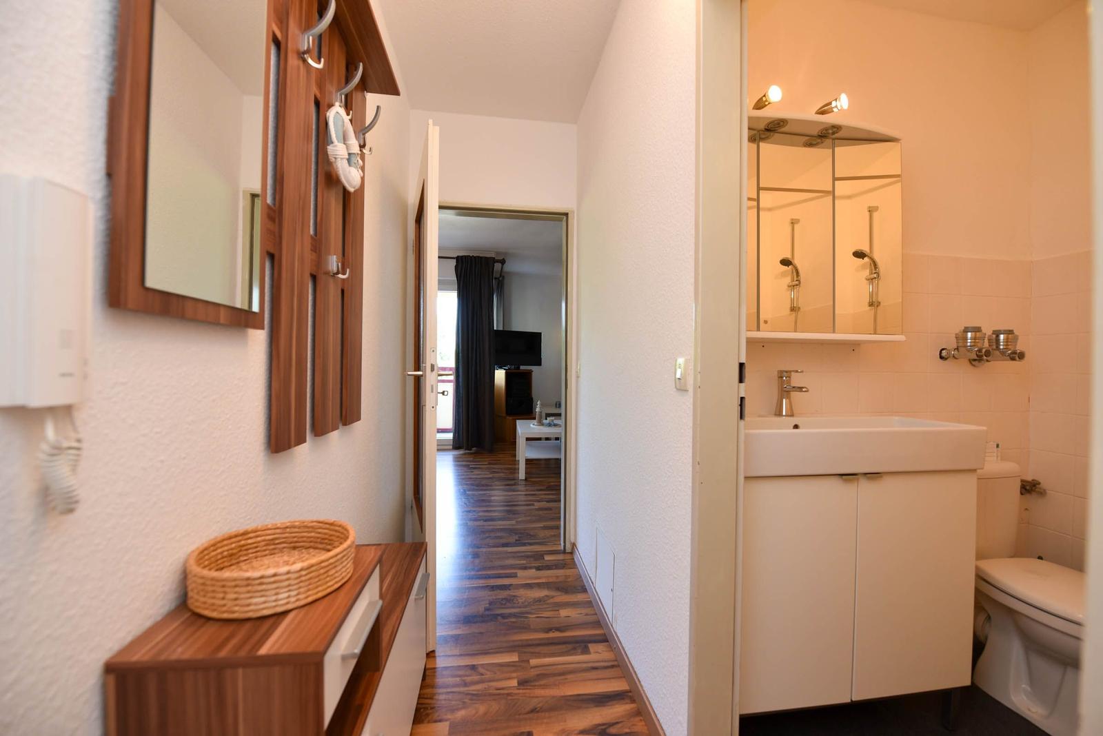 Flur mit Badezimmer und Blick in Wohnbereich mit Holzboden