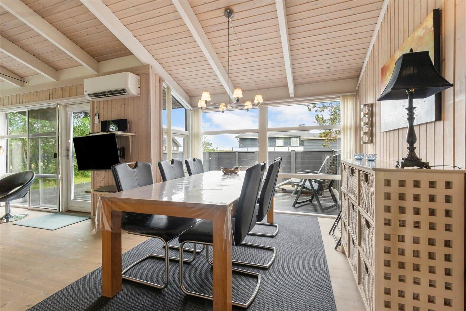 Dining area with table, chairs, and view of terrace