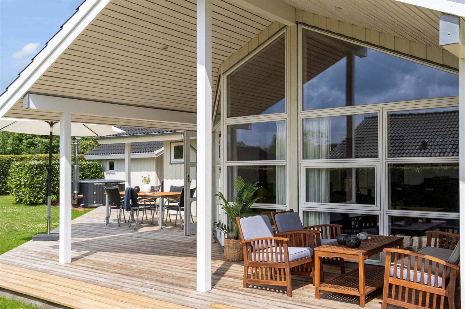 Terrace with seating and view into the house. Backyard with table and chairs.