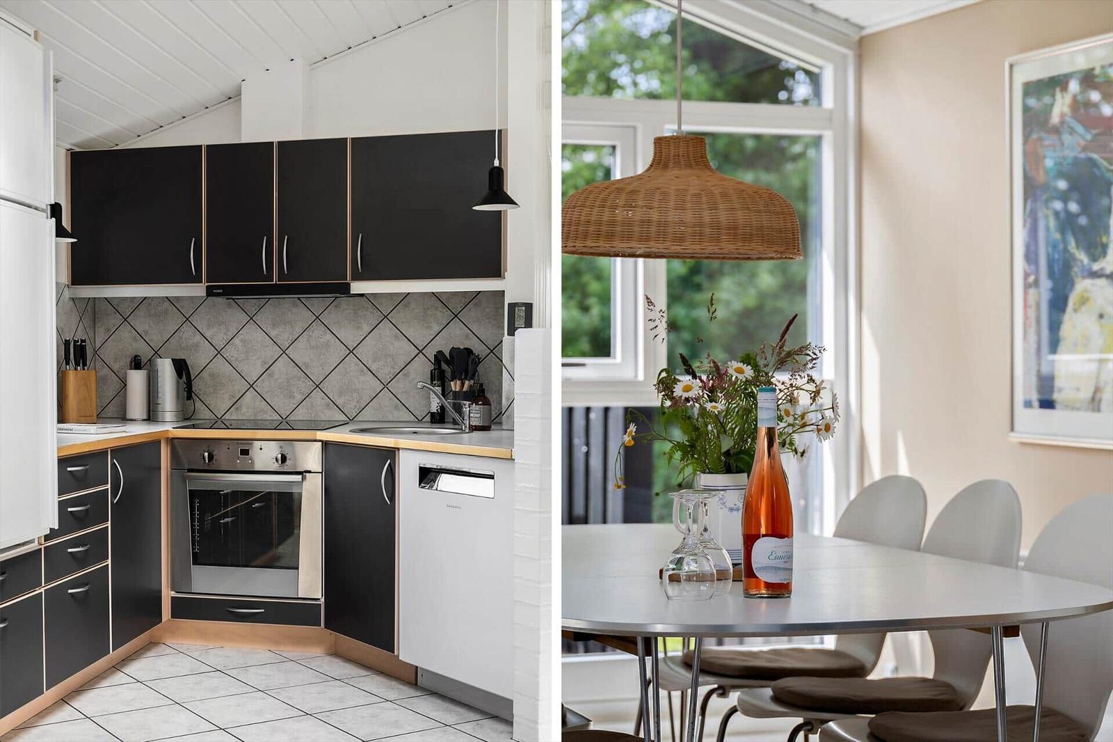 Kitchen with black cabinets and dining area with table and chairs.