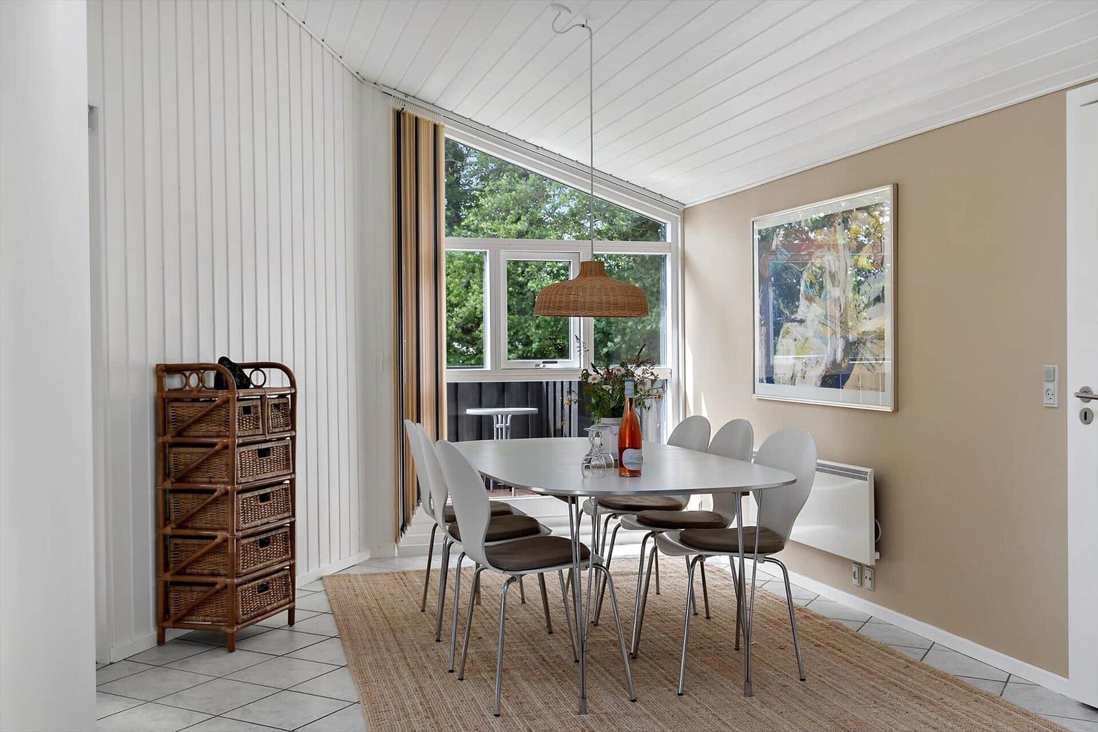 Dining room with table, chairs, and window to the outside.