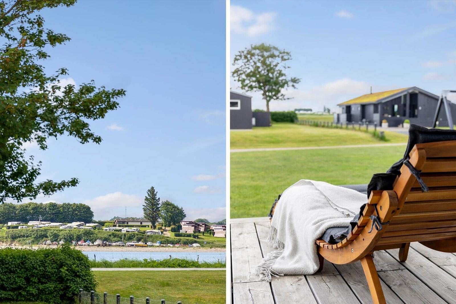 View of a lake with a campsite and modern wooden cabins with a terrace.