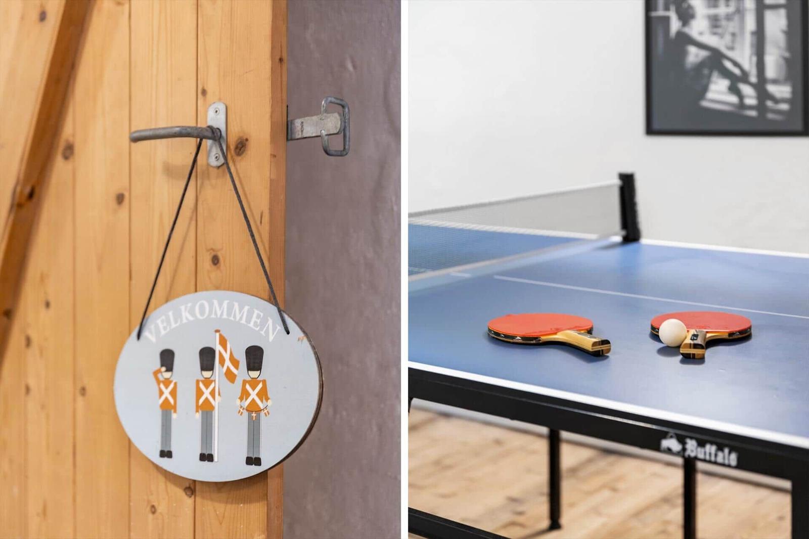 Willkommensschild an Holztür und Tischtennisplatte mit Schlägern und Ball