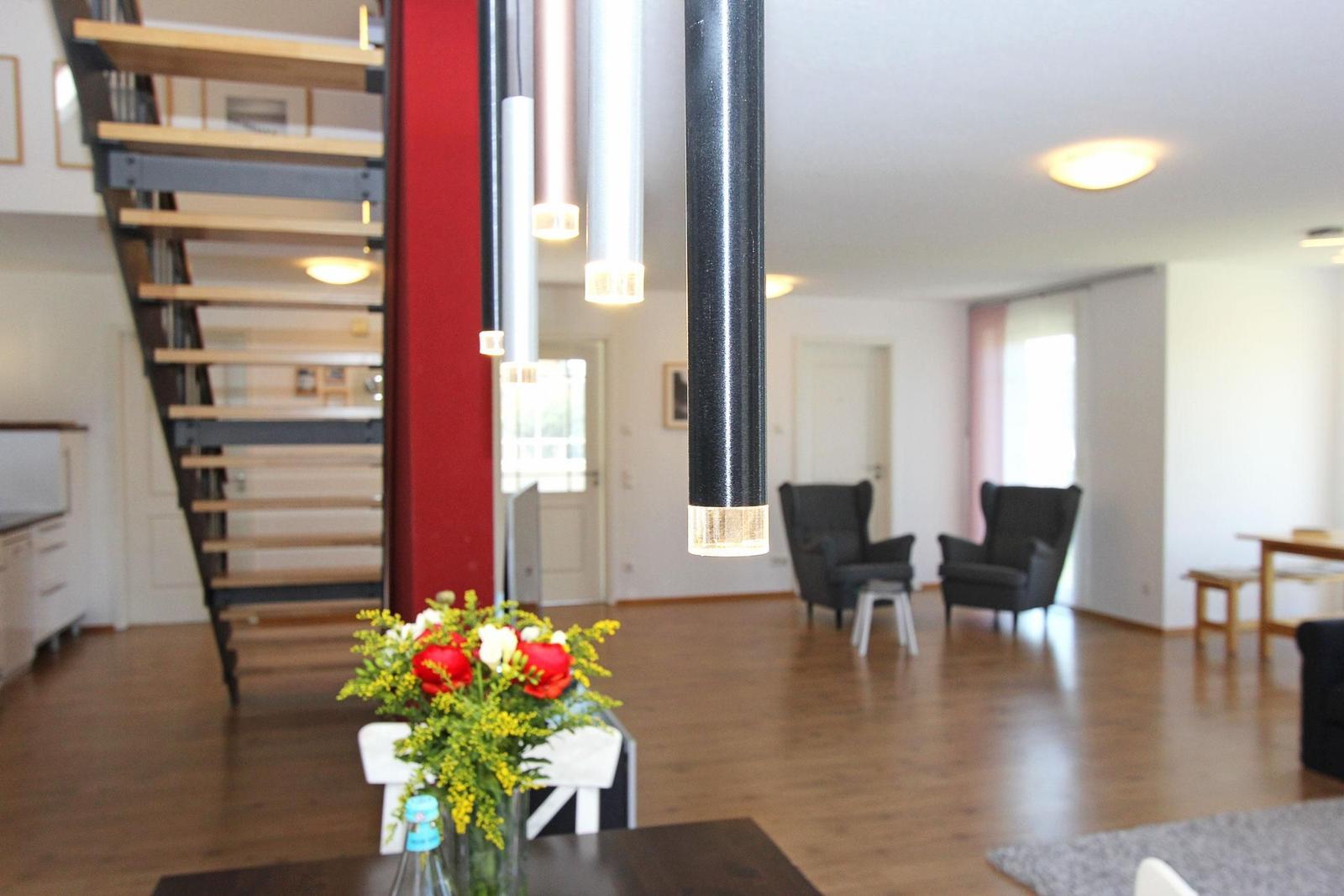 Haus mit offener Küche, Wohnbereich und Treppe zur oberen Etage.