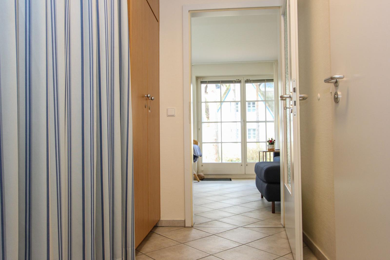 Flur mit Blick in Wohnbereich mit Fenster und Sofa