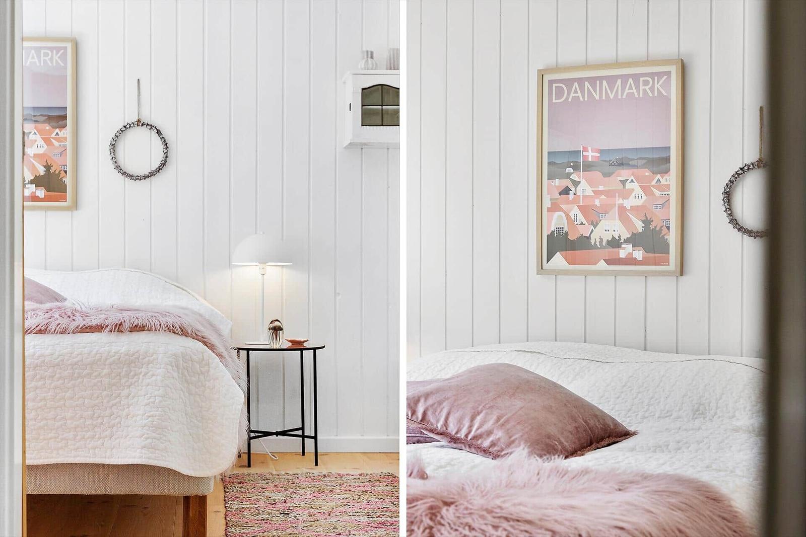 Schlafzimmer mit Bett, Wandbild und kleinen Tisch