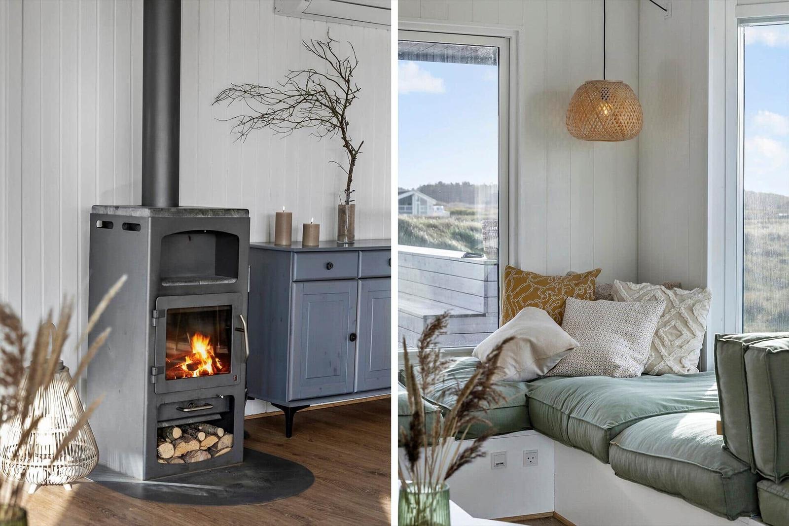 Kamin mit Holz und Küchenmöbel. Sitzbank mit Kissen und Fensterblick.