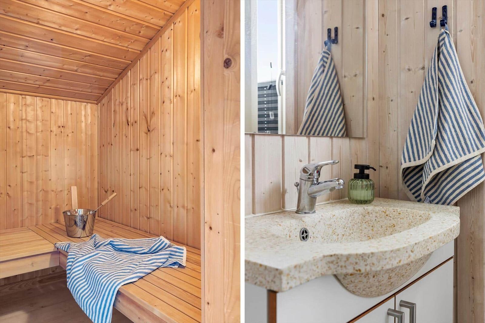 Holzsauna mit Bank und Eimer. Bad mit Waschbecken und Handtuch.