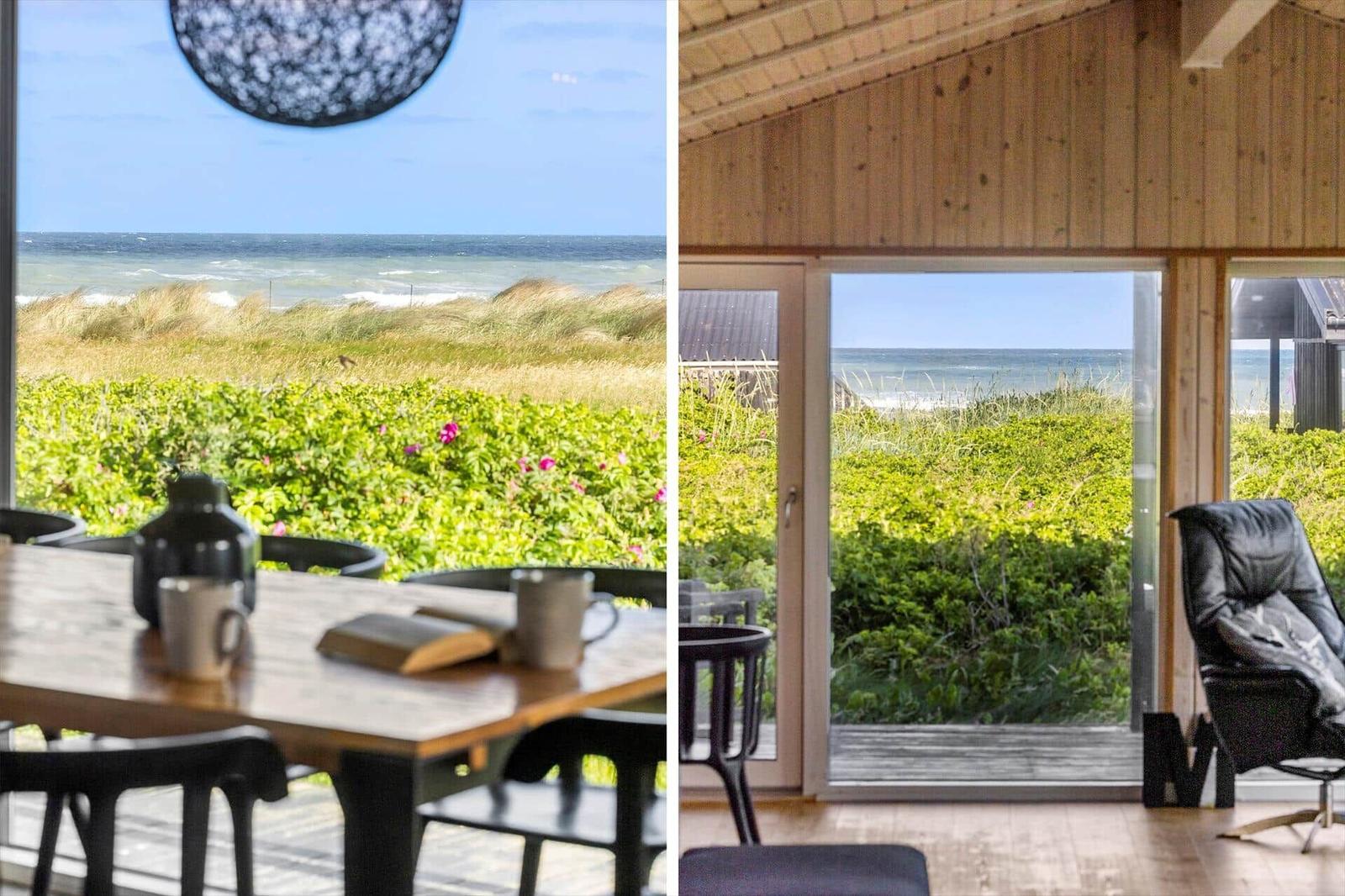 Haus mit Blick auf Strand und Dünen. Tisch mit Tassen und Buch. Sitzgelegenheit neben Glasfront.