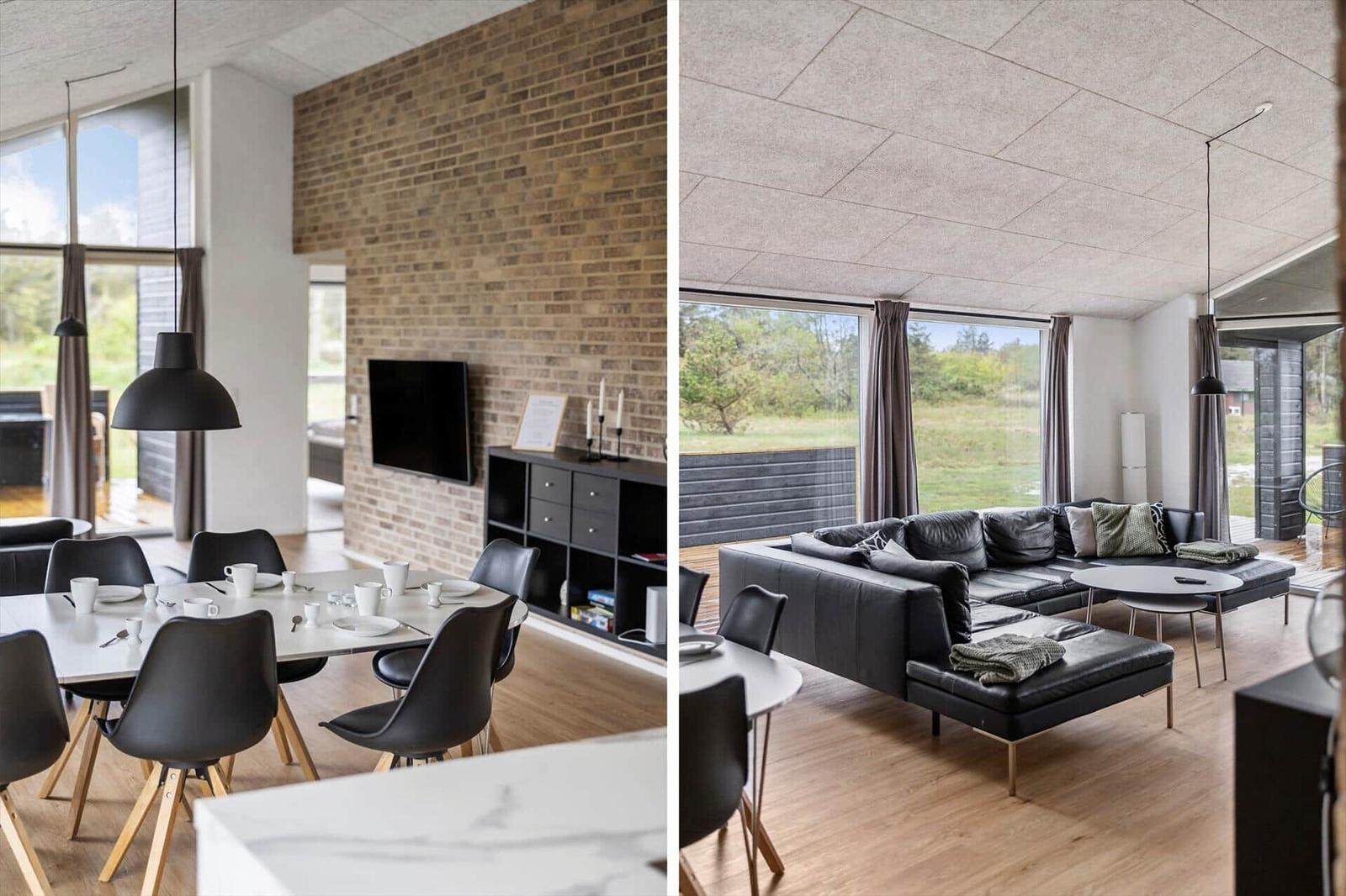 Modernes Wohn- und Esszimmer mit Steinwand, TV und großem Fensterblick.