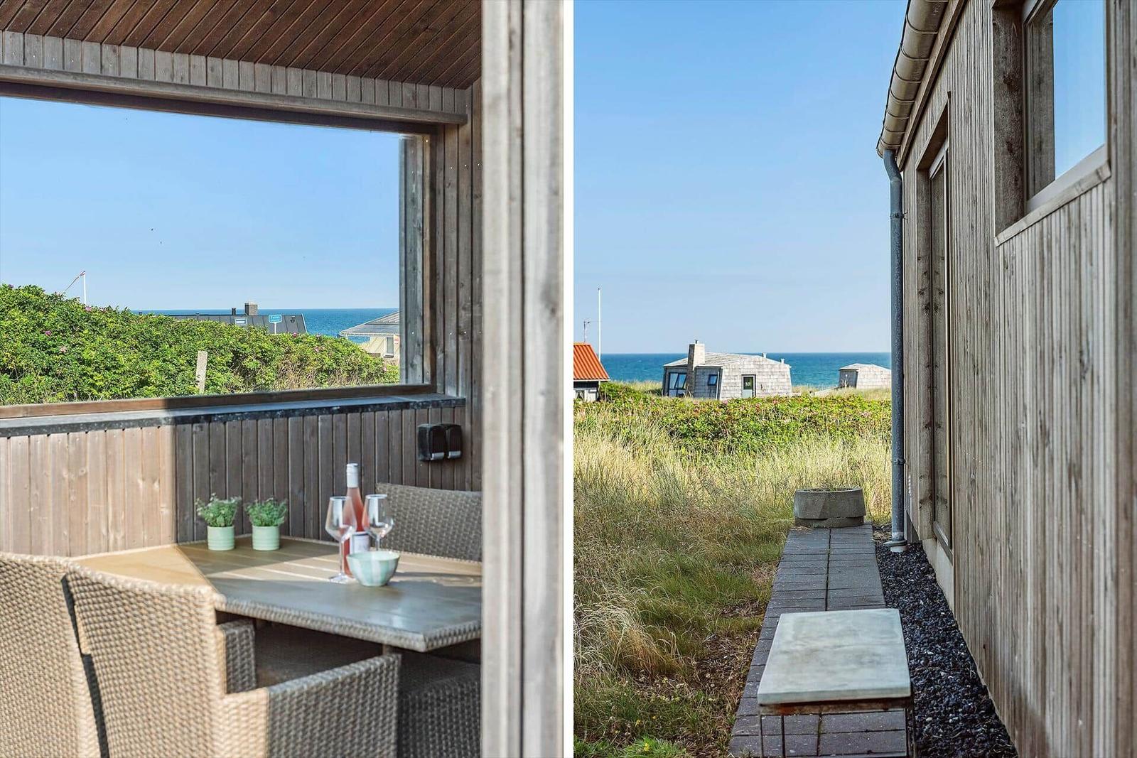 Terrasse mit Tisch und Stühlen, Blick auf das Meer und Grünflächen