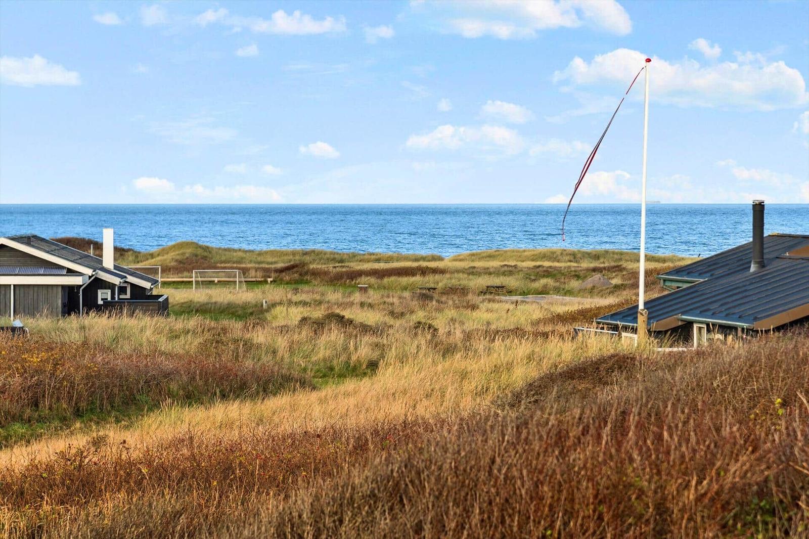 House with view of the sea and dune landscape.
